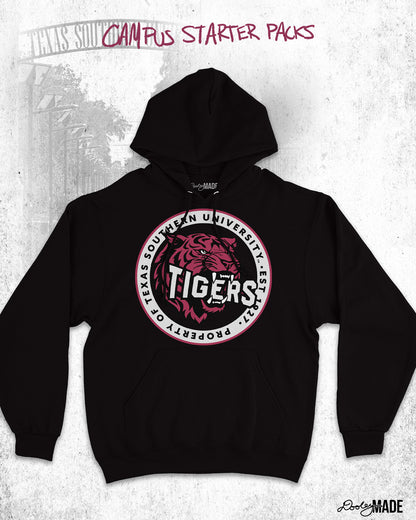 The image features a black hoodie with a circular emblem in the center. The emblem includes a stylized tiger head with the word "TIGERS" prominently displayed across the front. Surrounding the tiger in the circular emblem are the words "PROPERTY OF TEXAS SOUTHERN UNIVERSITY - EST. 1947." The background of the image has a faint, textured appearance with the words "CAMPUS STARTER PACKS" written at the top in a handwritten style. The lower right corner features the "Dooley Made" cursive font logo.