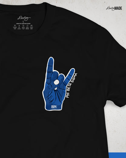 An image of a black Phi Beta Sigma Fraternity, Inc. Shirt featuring a large Sigma Hand Sign. 1914 is written on the wrist in bold black font and "Phi Beta Sigma" is written in along the side in a handwritten font.