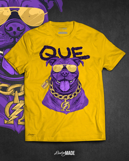 A photo a gold shirt with a graphic of an Omega Psi Phi themed Pit Bull Dog wearing gold aviator sunglasses and a gold Omega Psi Phi necklace.