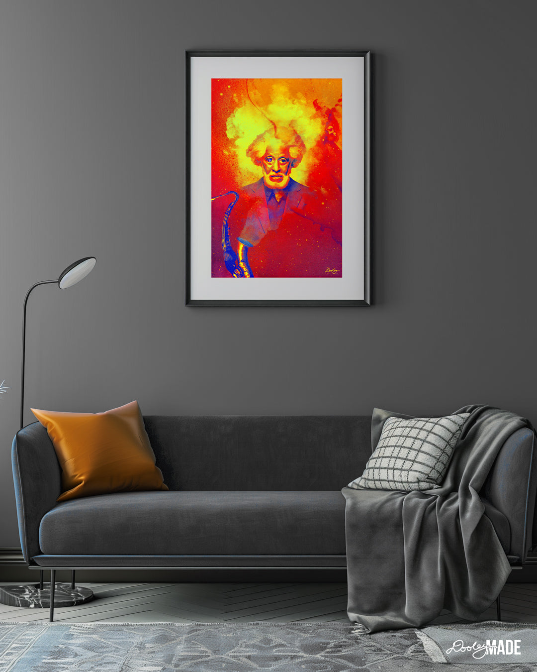 Frame photo on the wall of gray room with a gray couch. Frame has dreamy artwork of Jazz Saxophonist Sonny Rollins titled "Blowin' Smoke." A saxophone is blowing a hazy smoke cloud that materializes into an image of Sonny Rollins with emphasized facial features. There are blue galaxies and universes within his eyes. The color palette is hues of orange, yellow, gold, red, purple and blue.