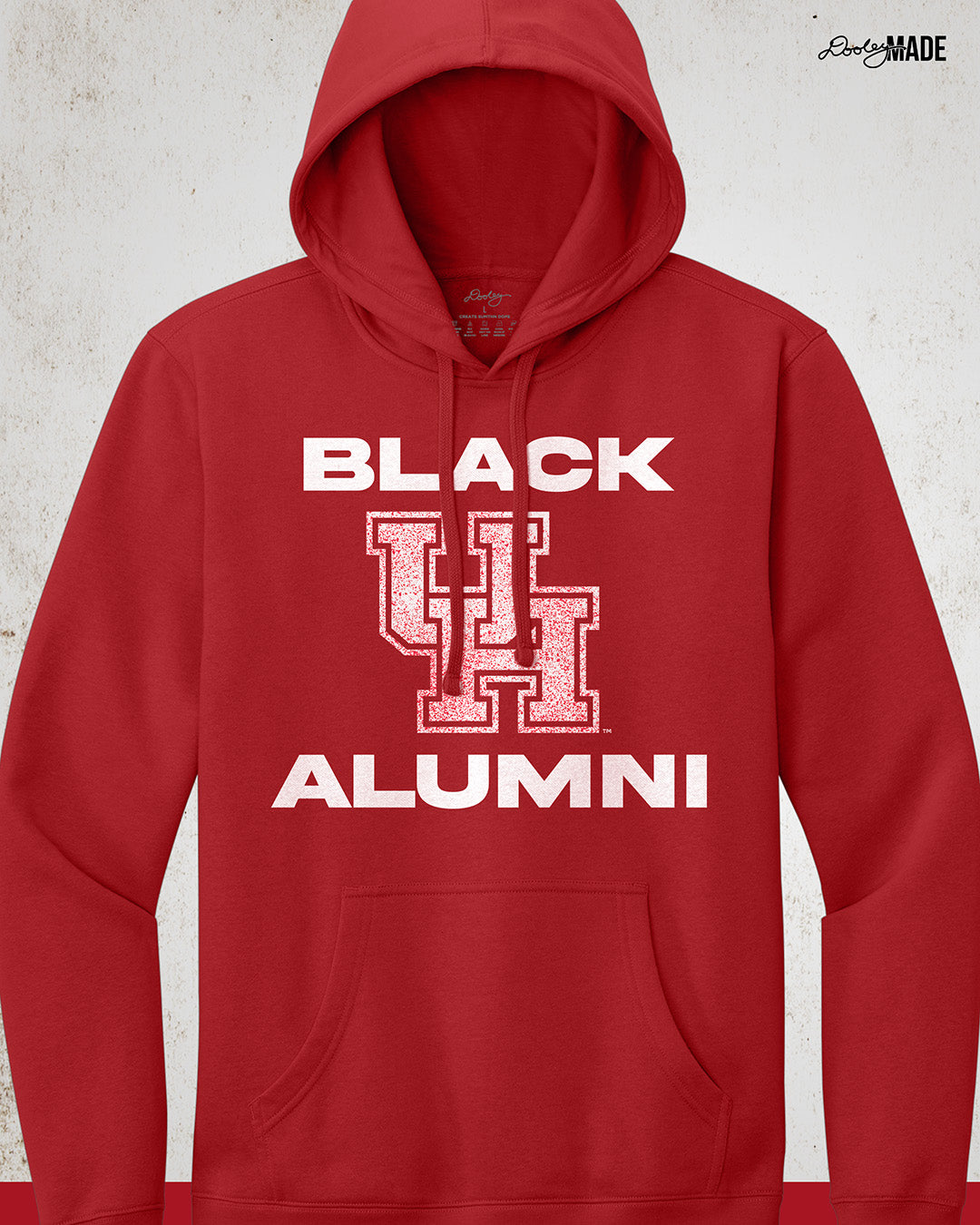 Image of a "Black UH Alumni Hoodie" with bold, white text reading "BLACK ALUMNI" surrounding a speckled red "UH" logo in the center. The design highlights pride and unity for Black Alumni of the University of Houston, presented on a modern and stylish garment perfect for showing school spirit.