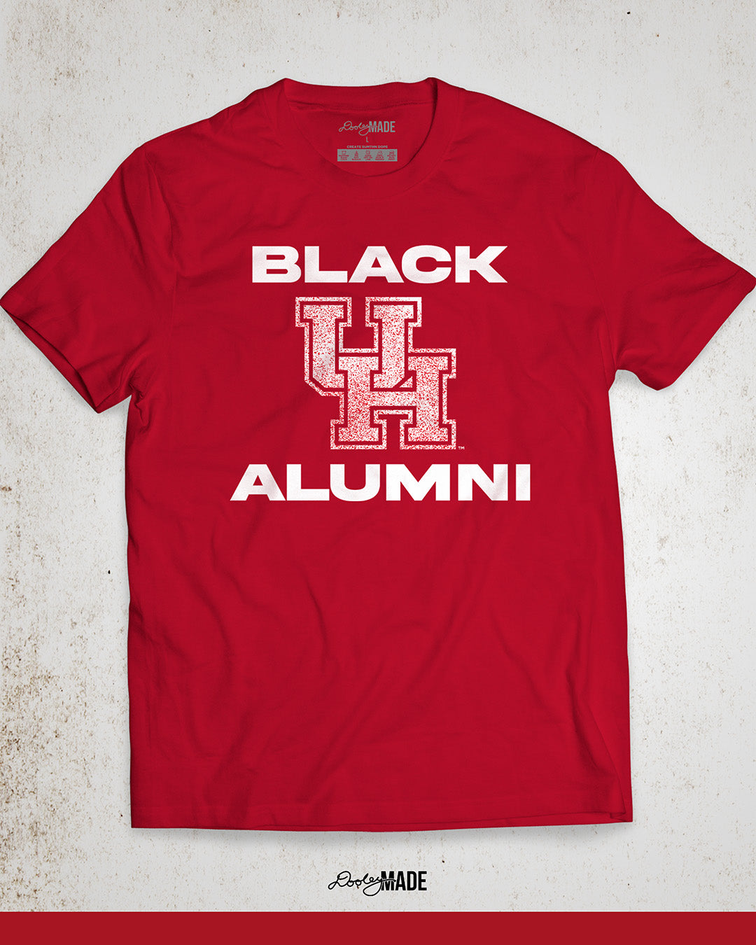 Image of a red "Black UH Alumni Shirt" with bold, white text reading "BLACK ALUMNI" surrounding a speckled red "UH" logo in the center. The design highlights pride and unity for Black Alumni of the University of Houston, presented on a modern and stylish garment perfect for showing school spirit.